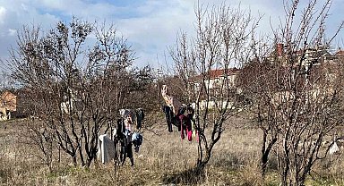 Kış ortasında kuruması için ağaca asılan elbiseler