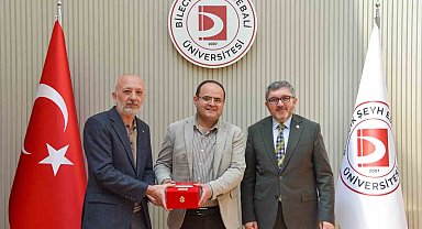 BŞEÜ'ye gümüş madalya ve madalya beratı takdimi