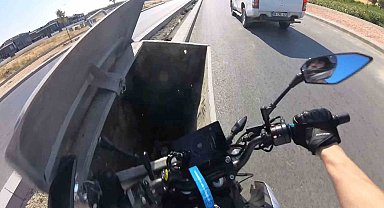 Önündeki aracı sollamaya çalışan motosiklet sürücüsü yola bırakılan çöp konteynerine çarptı